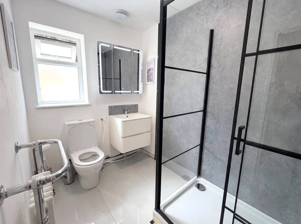 Finished shower room with black-framed enclosure
